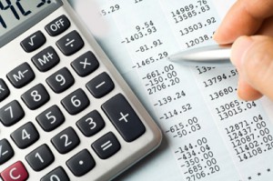 A calculator, pen, and financial statement.